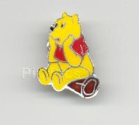 Winnie Pooh on a log