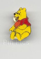 Winnie Pooh siting with hunny in his hand